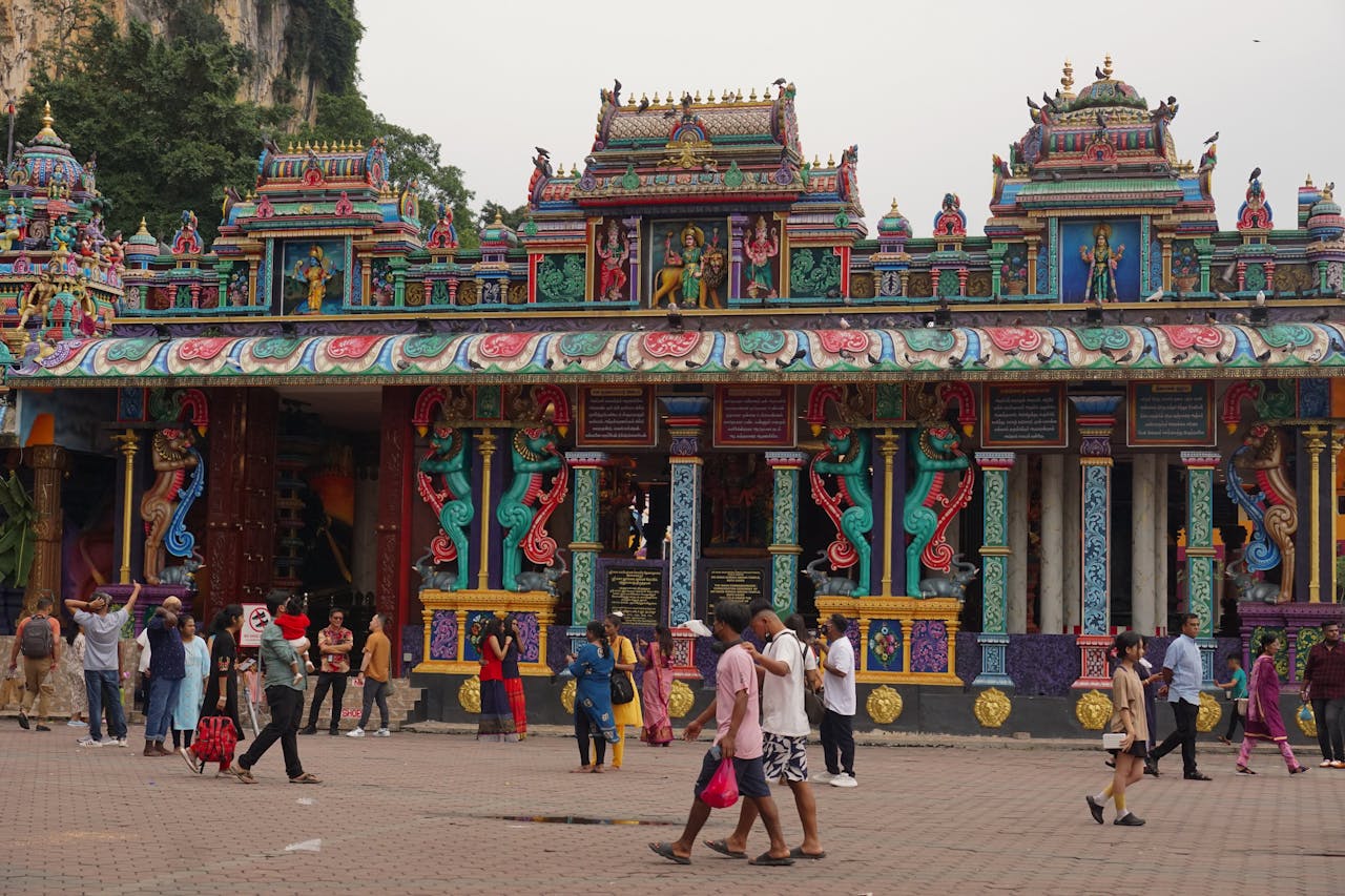 Colorful Sri Maha Mariamman Temple with diverse visitors in Malaysia.
