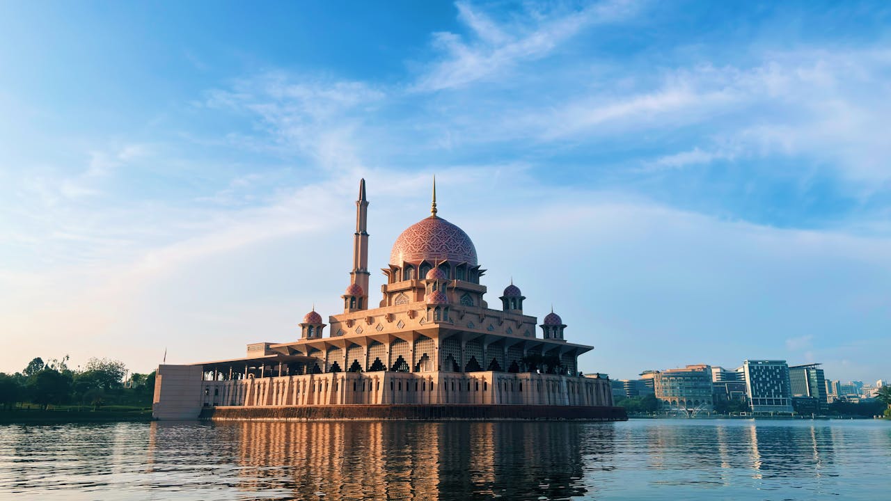 Scenic view of the majestic Putra Mosque in Putrajaya against a clear blue sky.