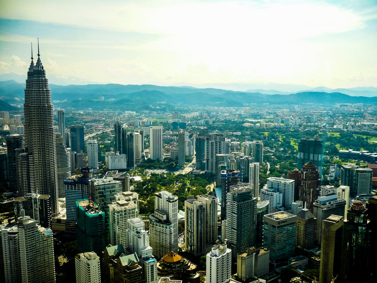Stunning aerial view of Kuala Lumpur showcasing the iconic Petronas Twin Towers and cityscape.